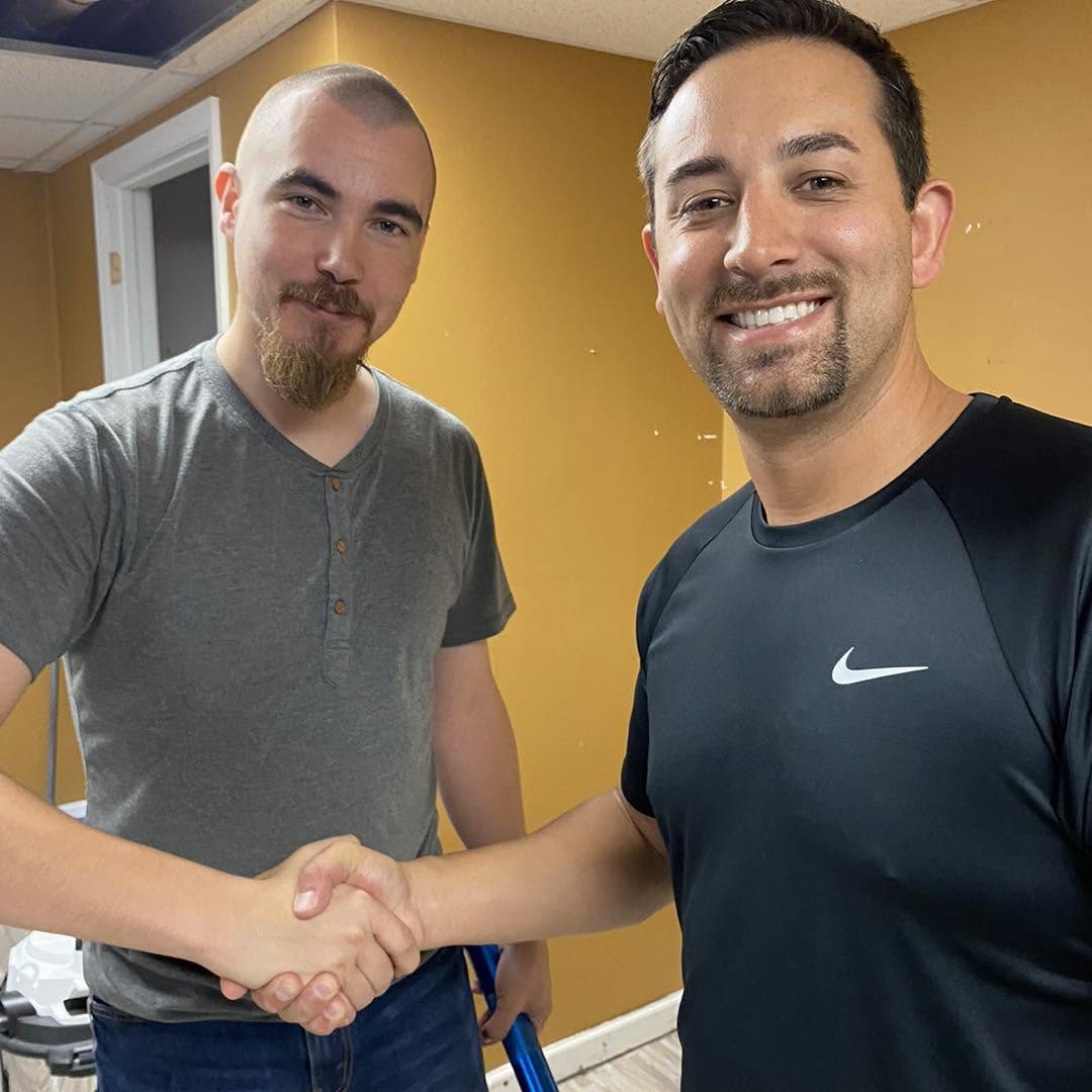 Ryan Trent shaking hands with a customer after a basement electrical job