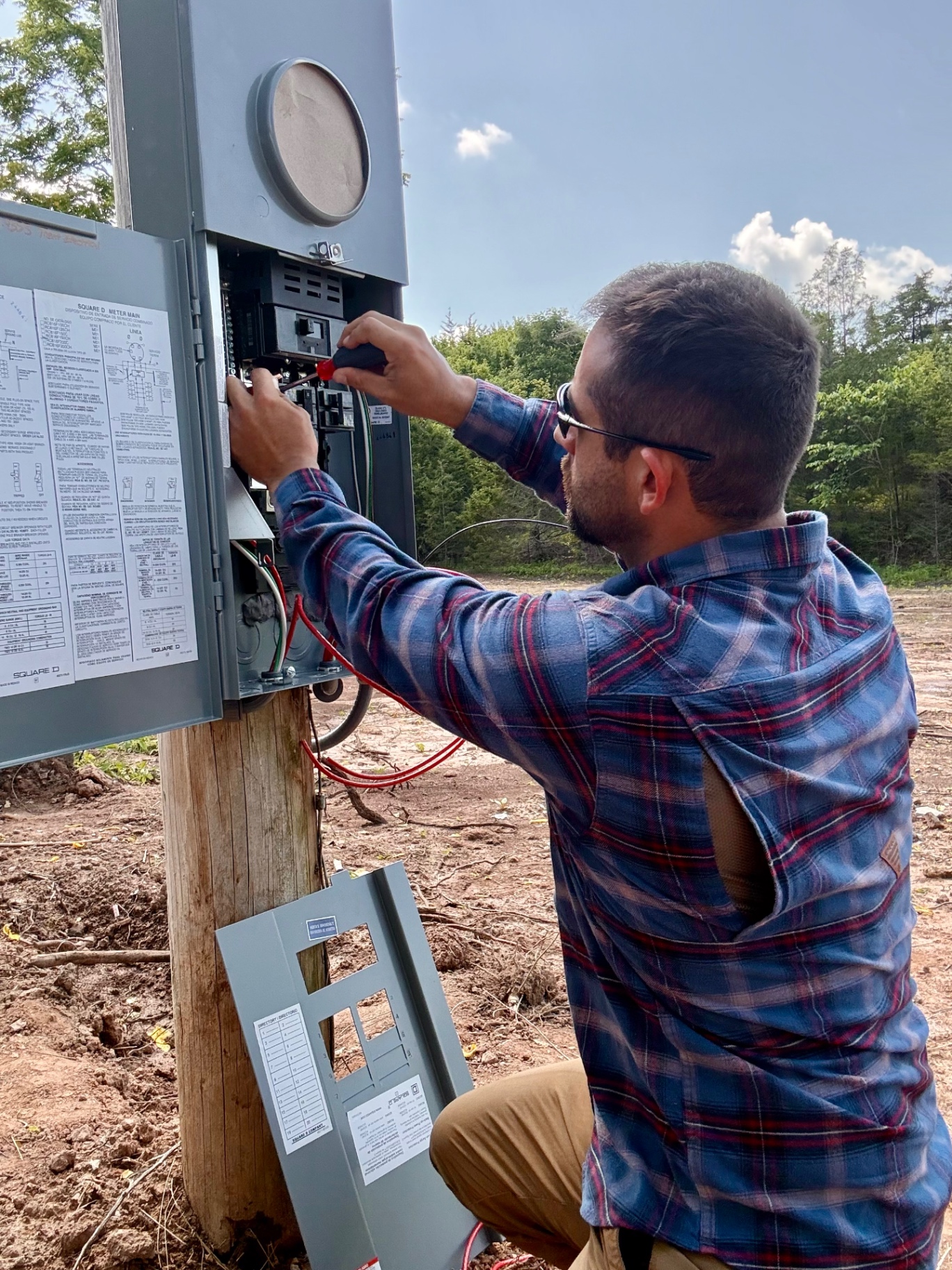 Ryan Trent working on a Square D meter main during a residential electrical service call.