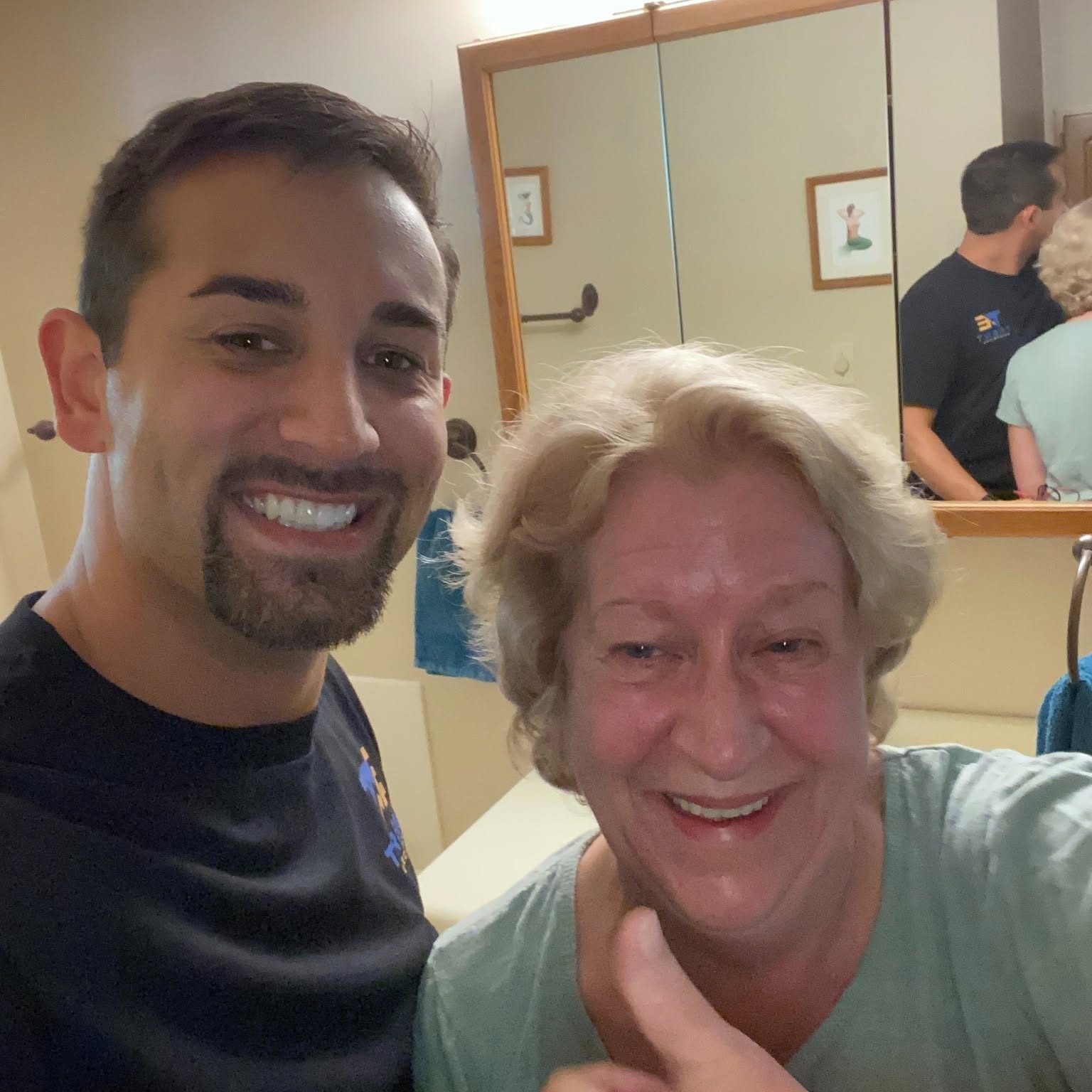 Ryan Trent with a customer after wiring her bathroom remodel