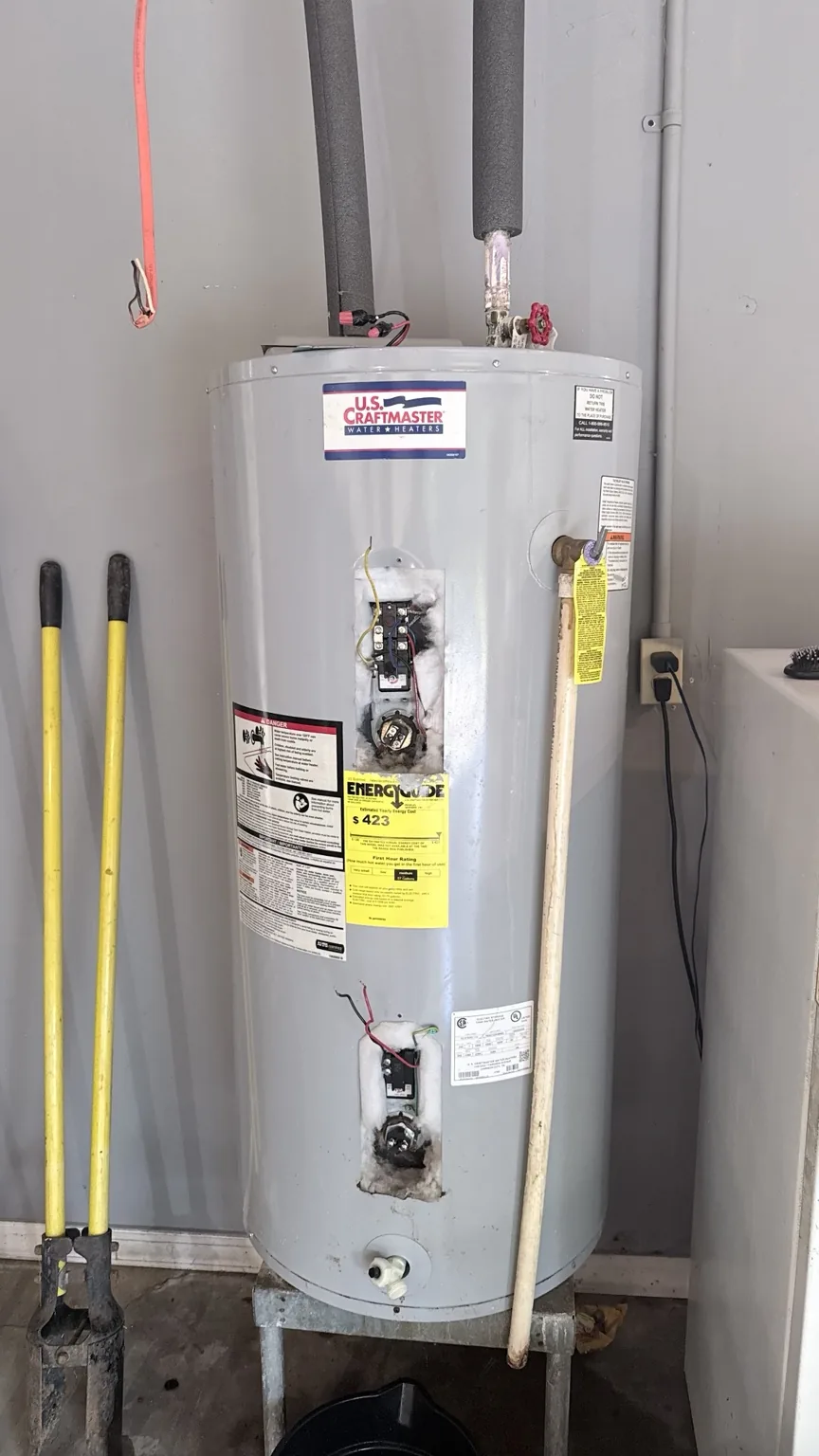 Water heater in Surgoinsville, TN with access panels open and wiring disconnected during electrical inspection