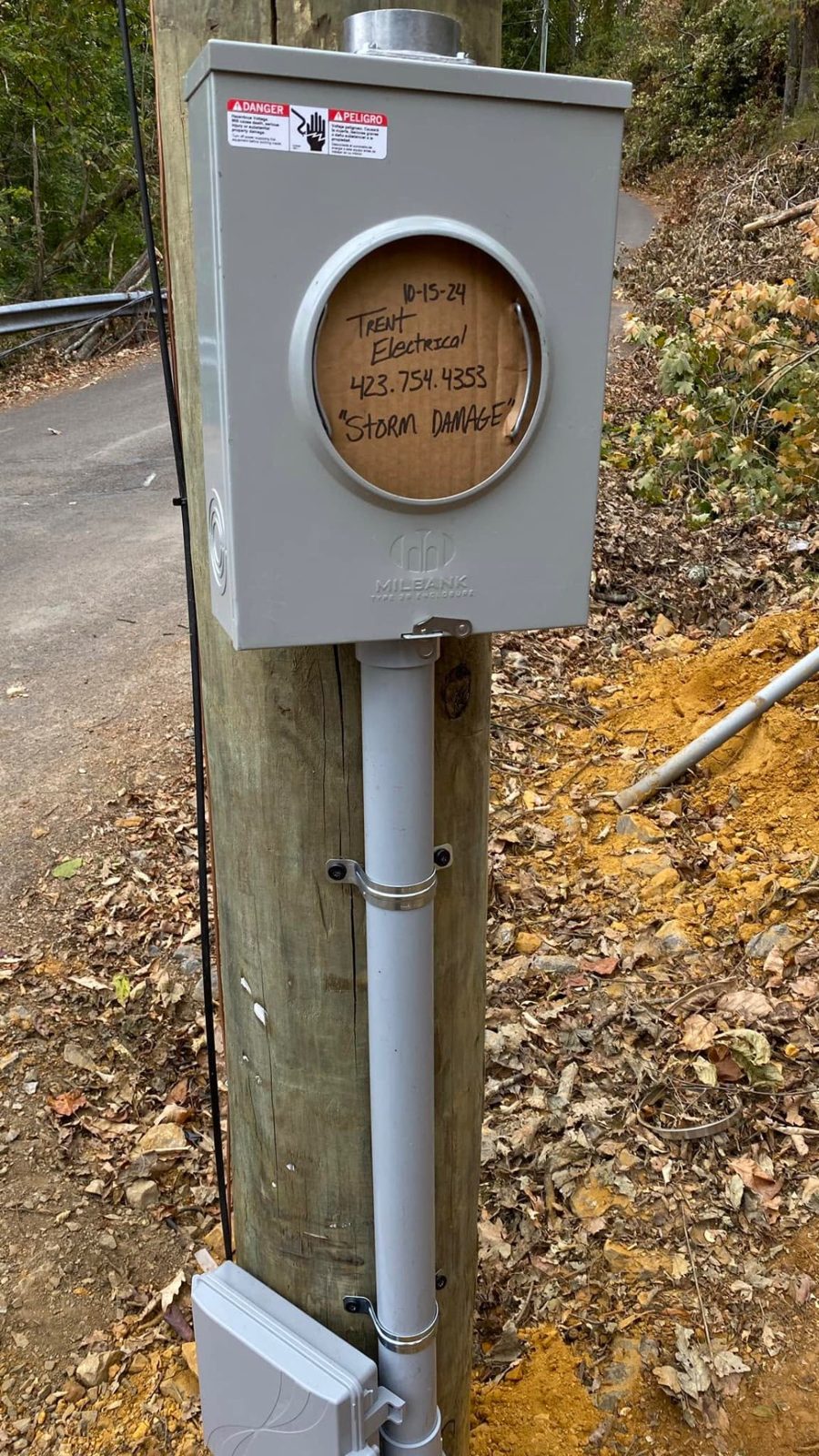 Temporary meter base mounted on a wooden utility pole after storm damage