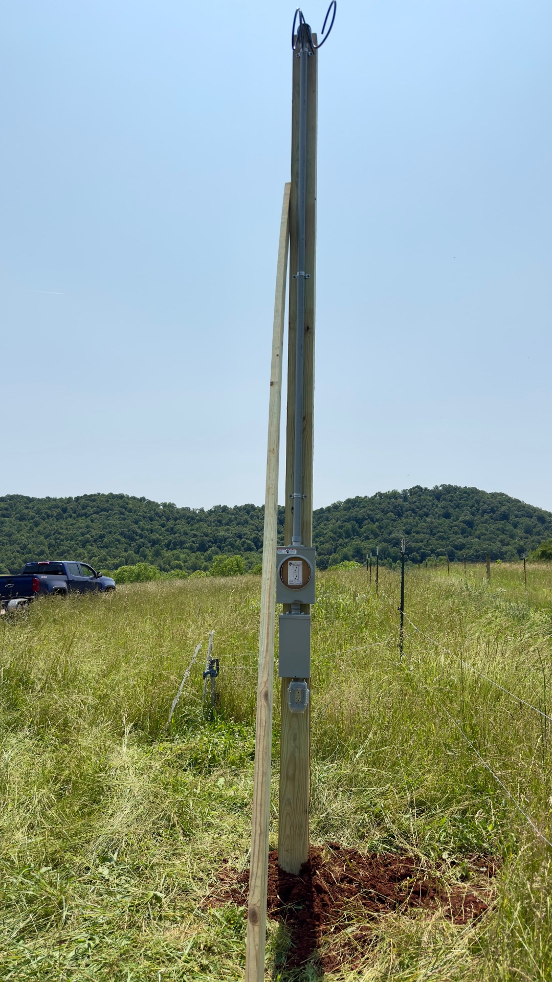 Utility pole with conduit and meter base in a Mooresburg TN field