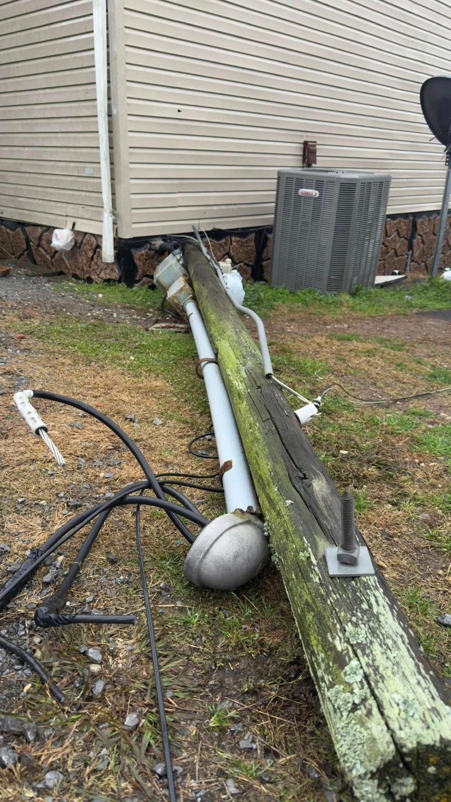 Utility pole knocked down beside a home after a storm in Hawkins County TN