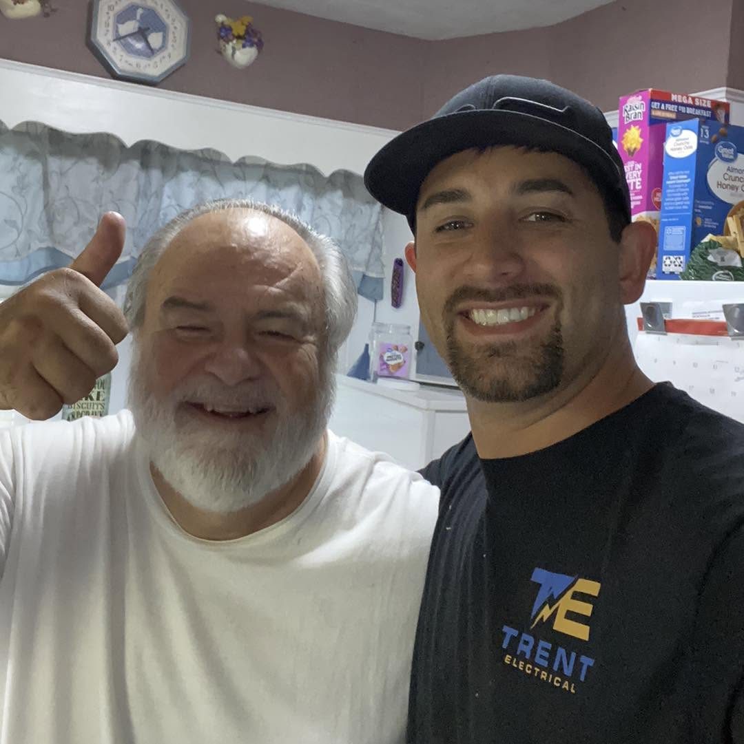 Ryan Trent with a homeowner in his kitchen after an electrical repair in Rogersville TN
