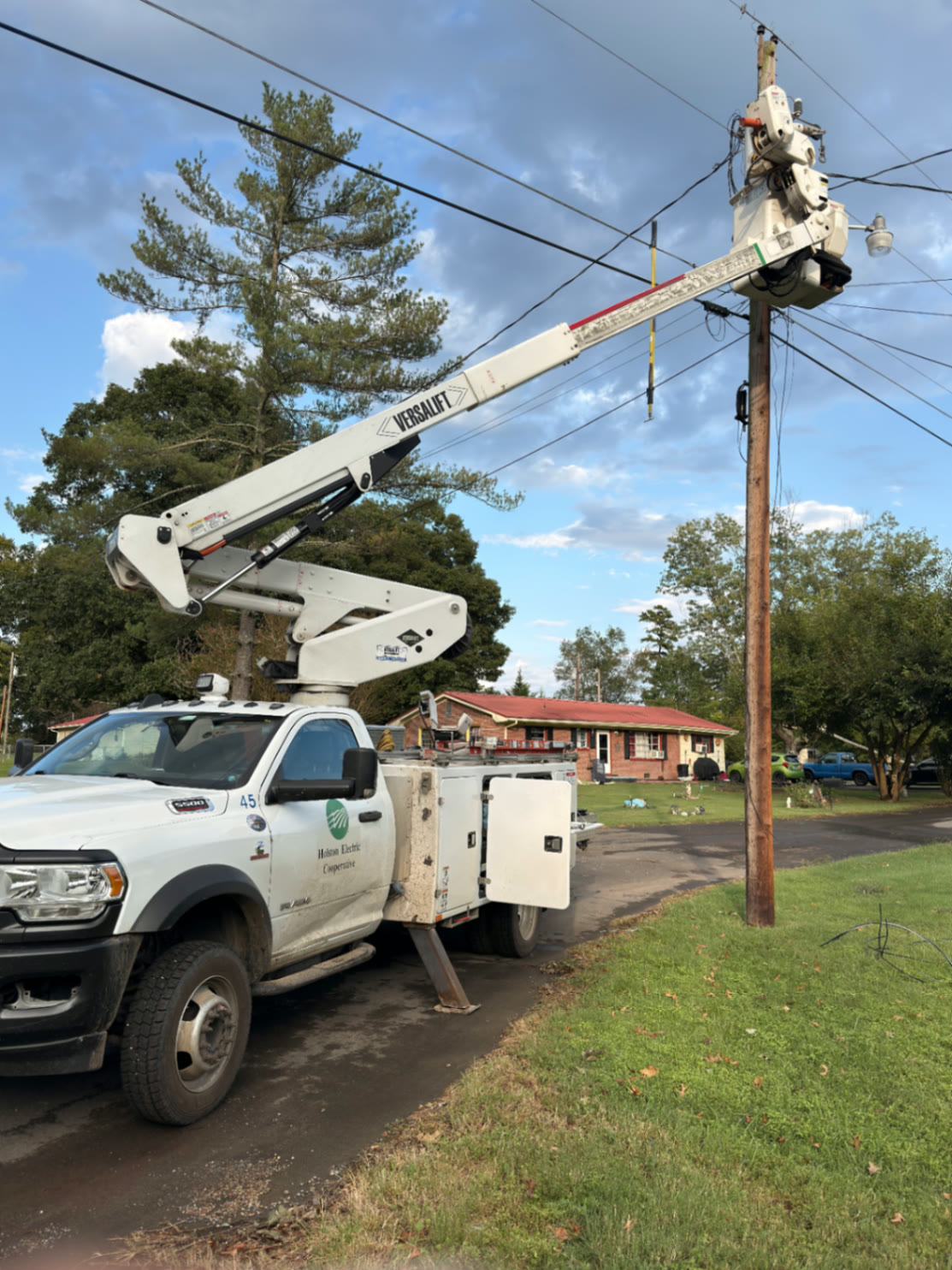 Holston Electric Cooperative bucket truck working at a utility pole during storm restoration