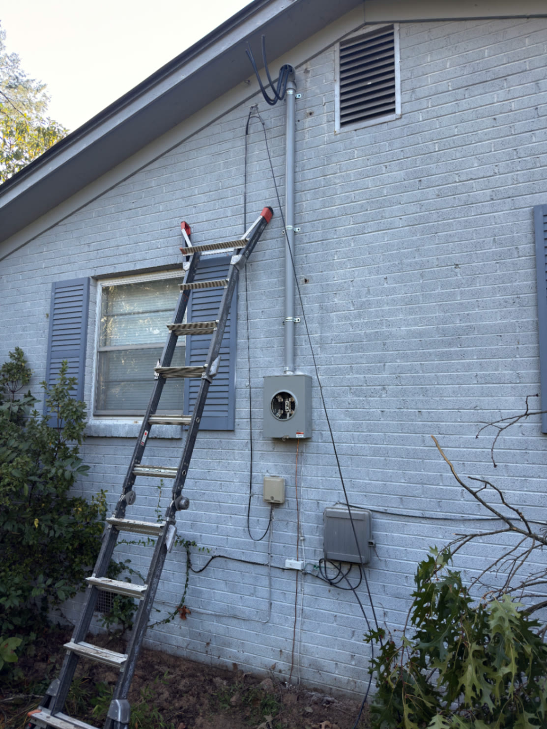 Damaged overhead electrical service mast and meter base on a Hawkins County home after a tree strike