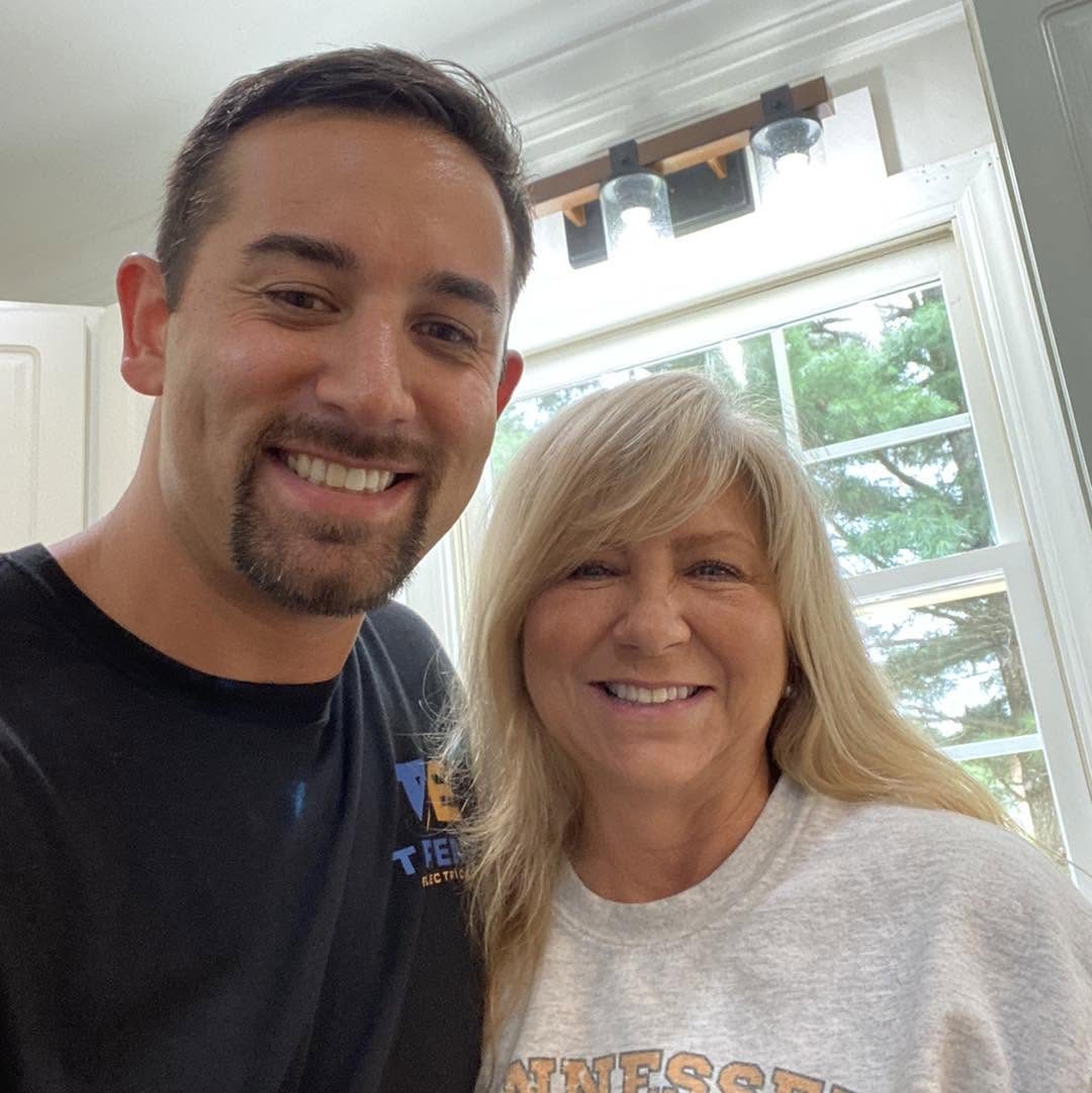 Ryan Trent with a homeowner after an electrical service call