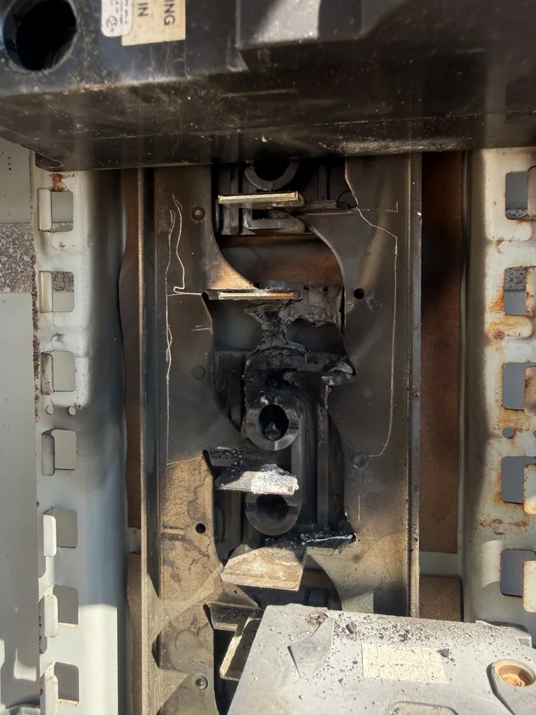 Close-up of the damaged bus connection inside the existing Surgoinsville electrical panel