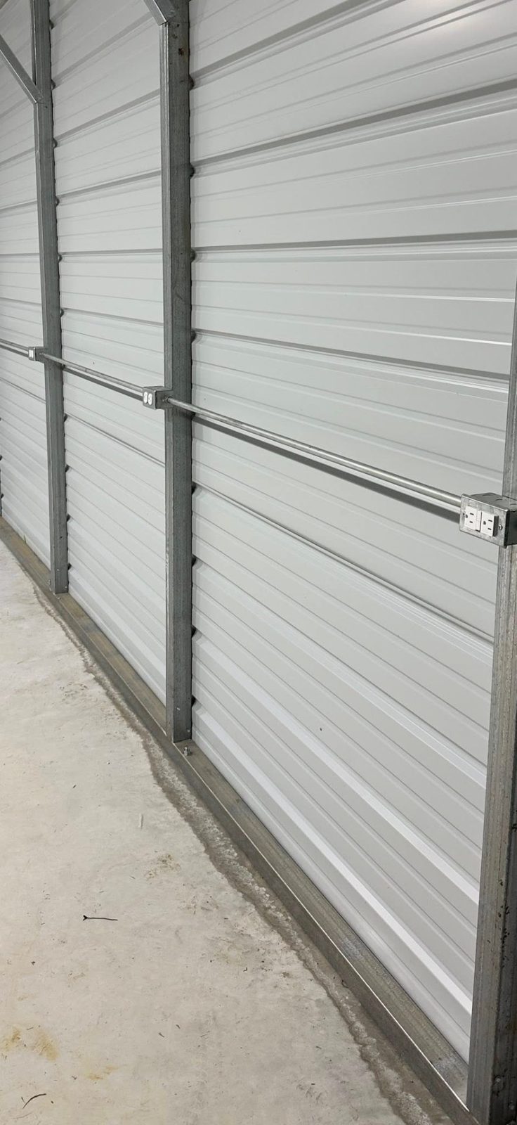 Row of outlets installed with EMT conduit along the wall of a metal building
